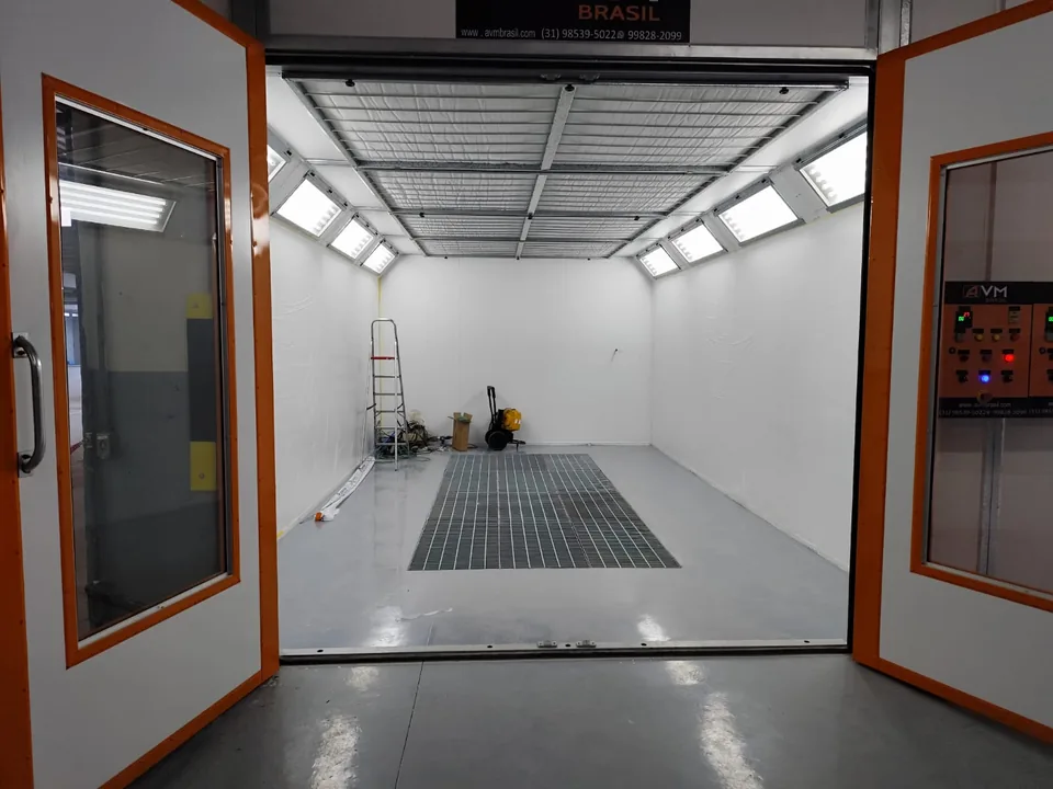 Interior de cabine de pintura com iluminação e grelha de piso